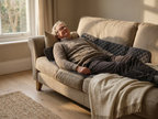 A man lying on his sofa with the Salureva traction mat across his back